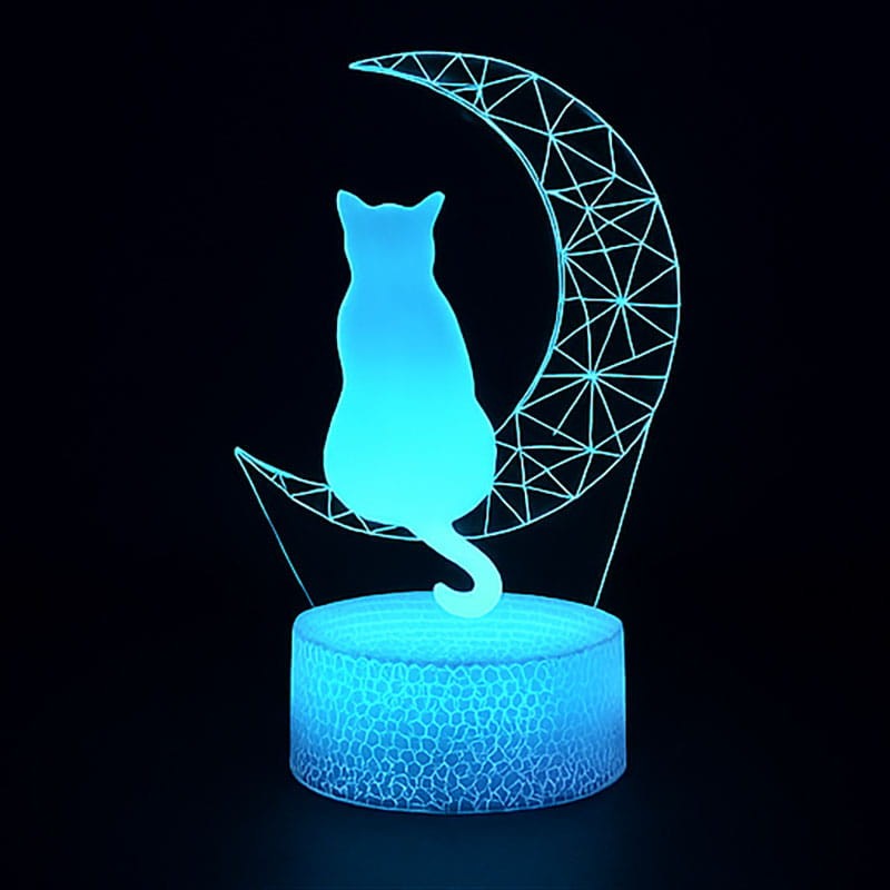 Lampka nocna 3D LED USB z motywem kota na księżycu – biała podstawa i kolorowe światło LED.